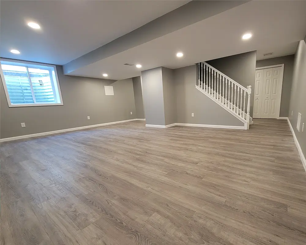 An empty basement with luxury vinyl flooring