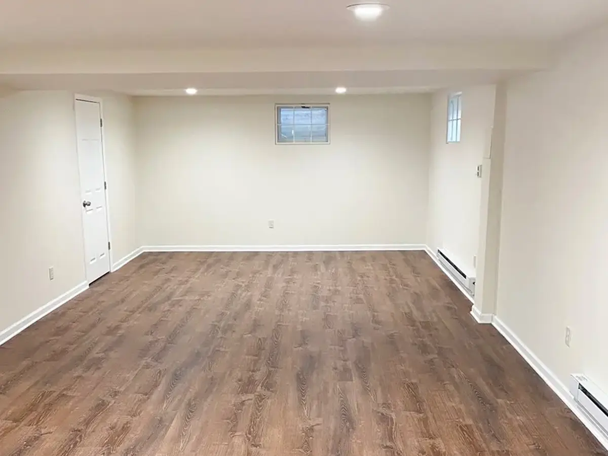 An empty basement with LVP flooring