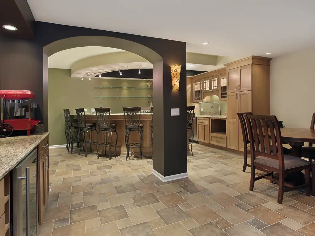 A basement with an open space kitchen and bar