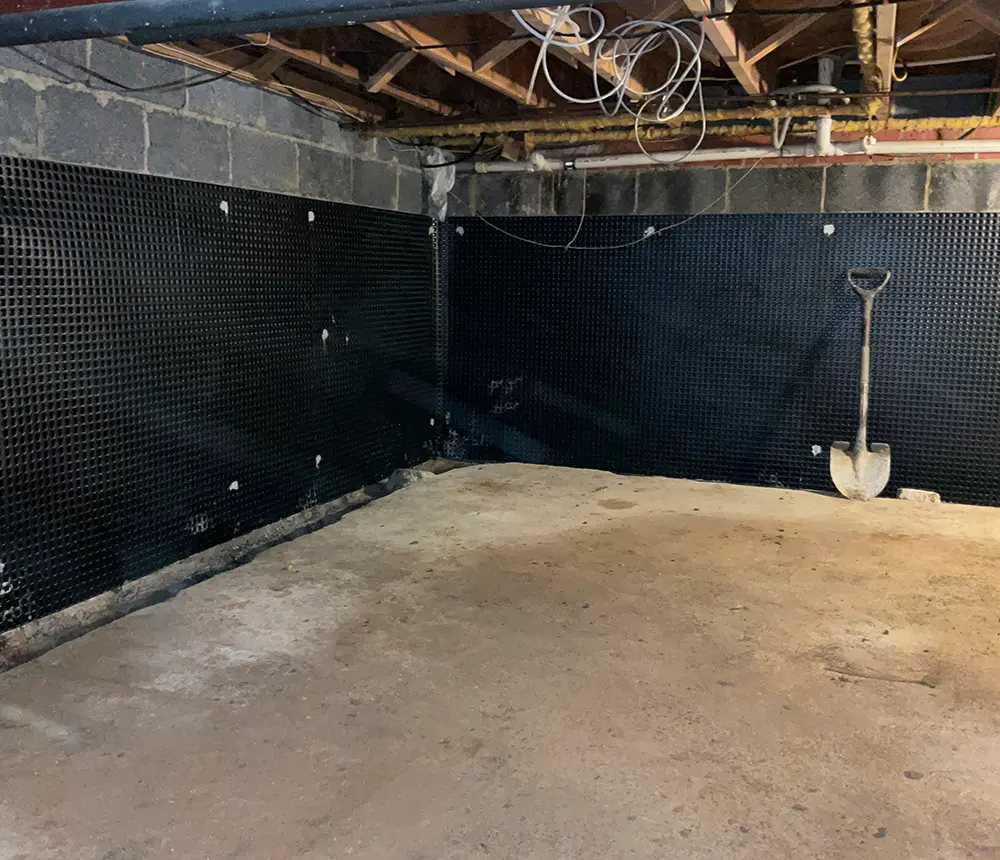 The concrete subfloor of a waterproofed basement
