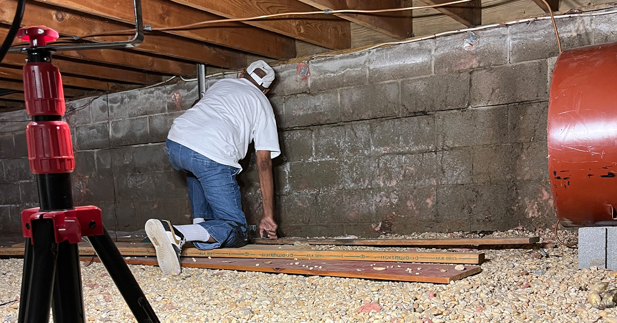 A contractor doing a foundation repair beneath a home