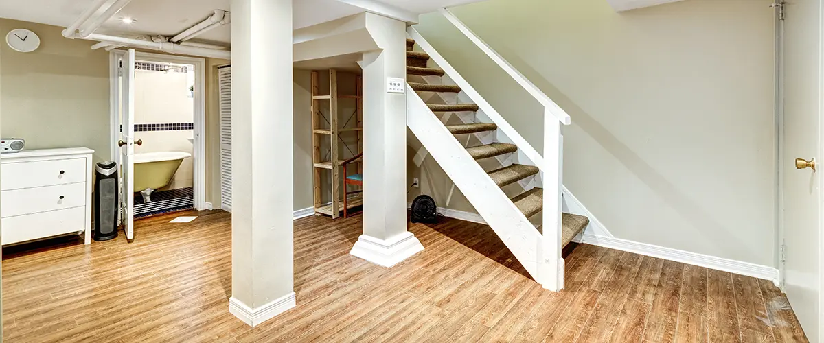 Living space with bedroom and half bath in a basement with LVP flooring