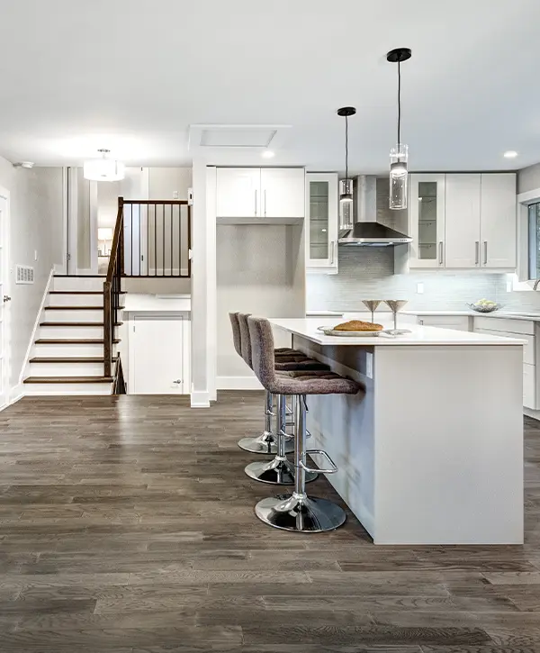 A basement with a kitchenette and LVP flooring