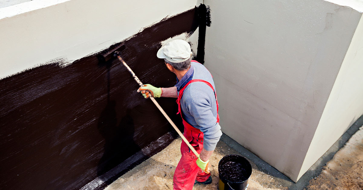 Man Performing Exterior Waterproofing Methods for House Wall Basement Waterproofing In Lanham, MD