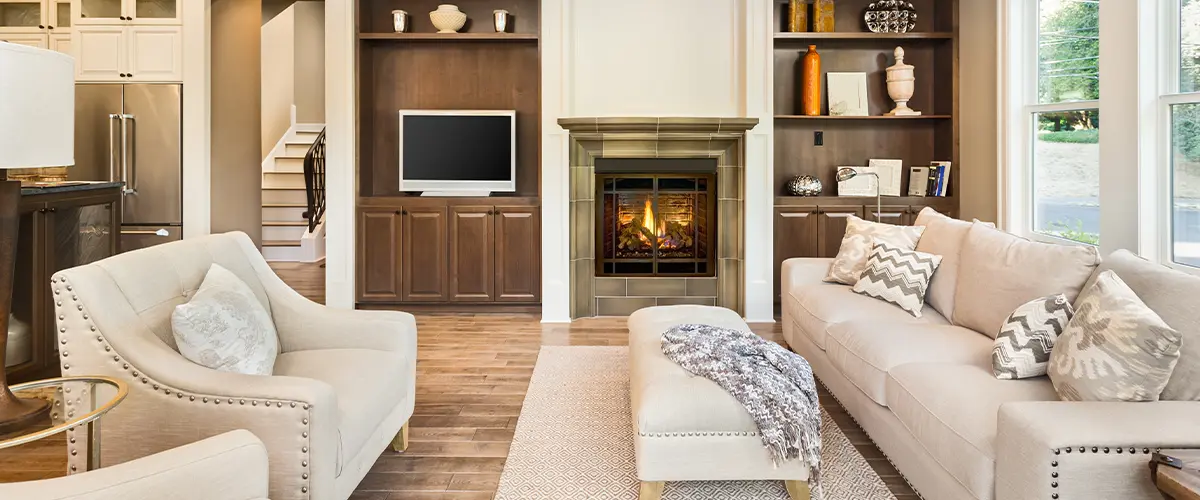 Elegant living room interior with fireplace, hardwood floors, and neutral tones.